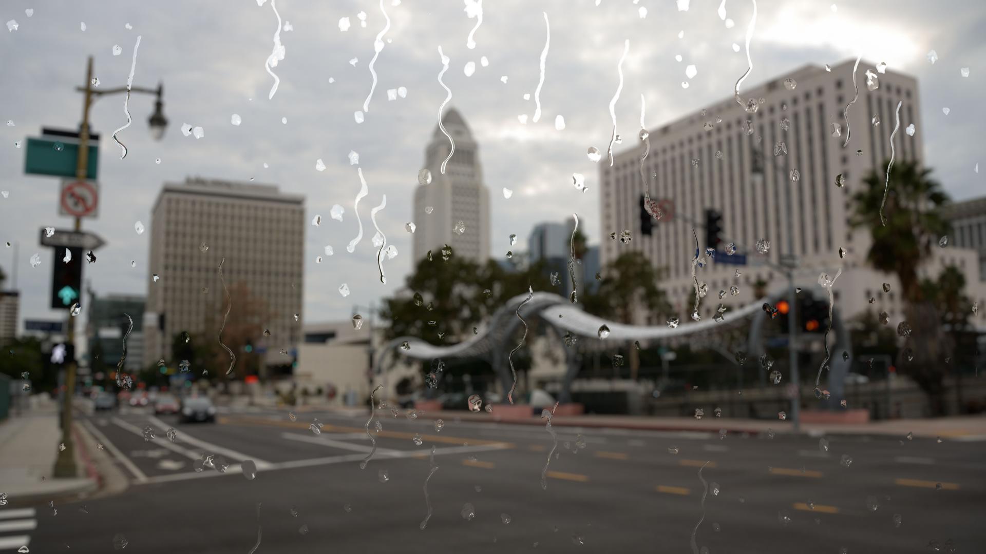 Rain in Los Angeles city center through a glass window